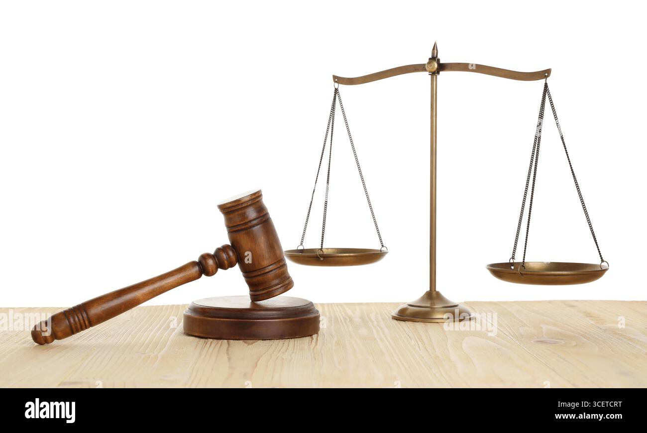 Golden scales of justice and gavel on wooden table against white ...