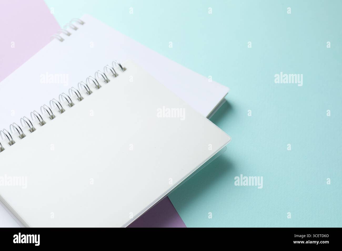White notebooks on color background, closeup. Space for text Stock Photo