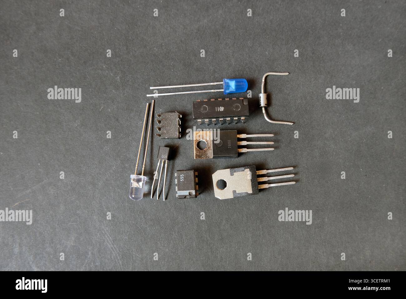 Semiconductor electronic elements on the black floor. Transistors, diodes and integrated circuits. Stock Photo