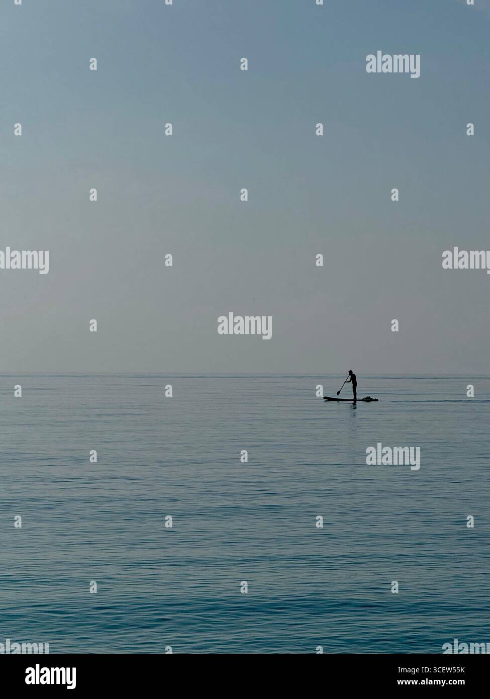 Turkey, Antalya, Konyaalti April 20, 2025: Earlier in the morning. Sea Plaid. Silhouette of a man. Man alone is floating on a SUP board. - Smartphone Captured Stock Image