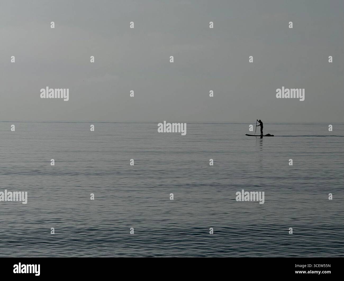 Turkey, Antalya, Konyaalti April 20, 2025: Earlier in the morning. Sea Plaid. Silhouette of a man. Man alone is floating on a SUP board. - Smartphone Captured Stock Image
