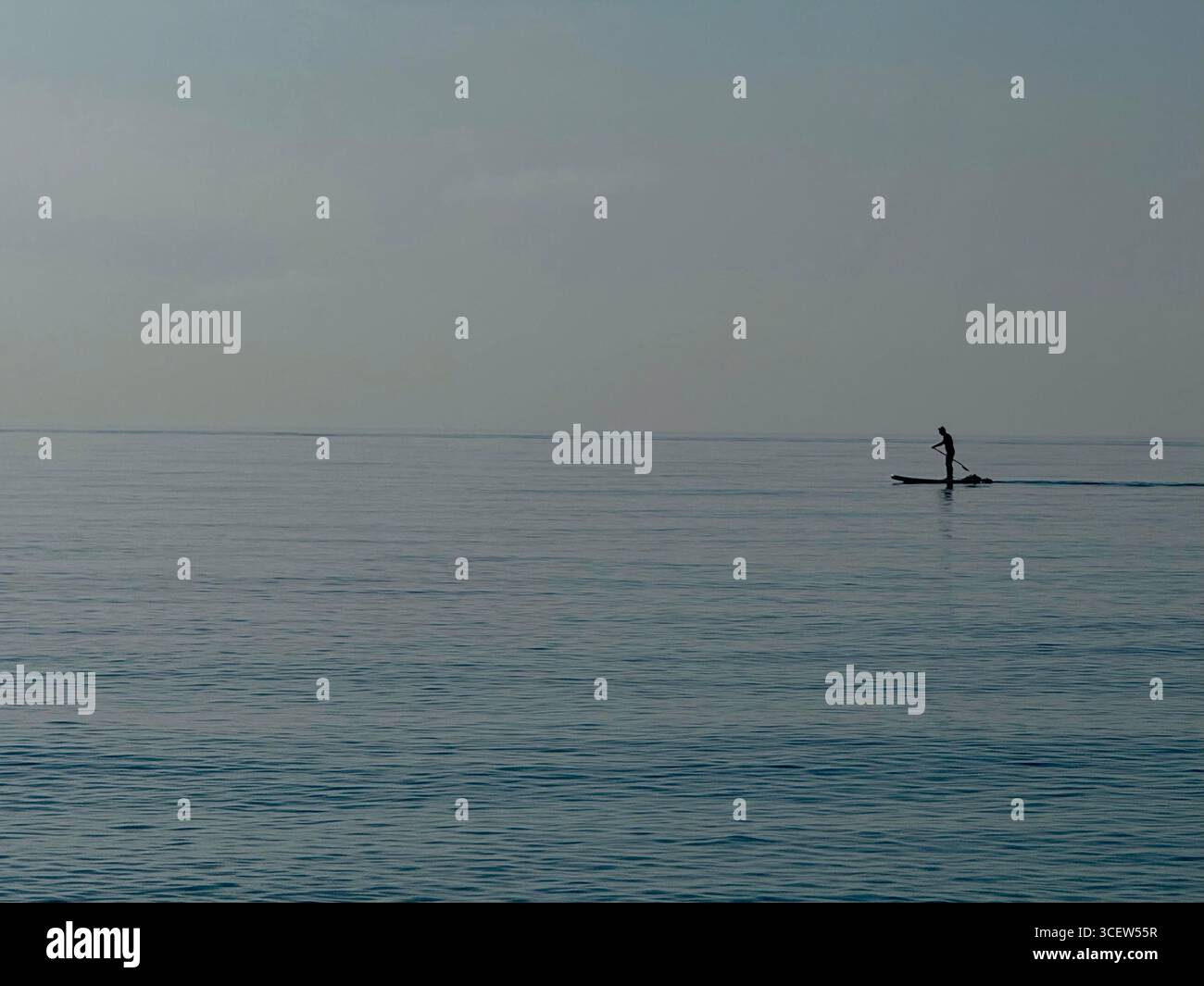 Turkey, Antalya, Konyaalti April 20, 2025: Earlier in the morning. Sea Plaid. Silhouette of a man. Man alone is floating on a SUP board. - Smartphone Captured Stock Image