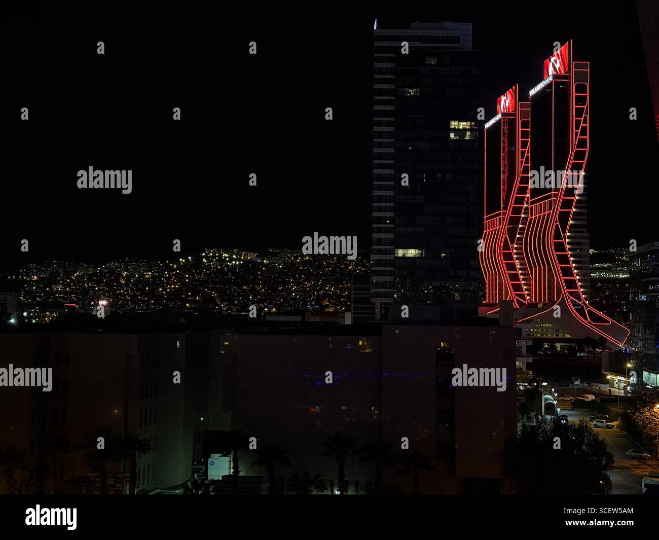 Turkey, Izmir 04/14/2025: Folkart towers. Night city. Bright lighting of buildings. Skyscrapers. Road, car headlights. Romantic night city - Smartphone Captured Stock Image