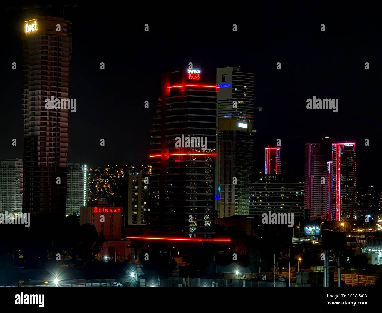 Turkey, Izmir 04/14/2025: Night city. The city of Izmir at night. Bright lighting of buildings. Skyscrapers. Road, car headlights. Romantic night city - Smartphone Captured Stock Image
