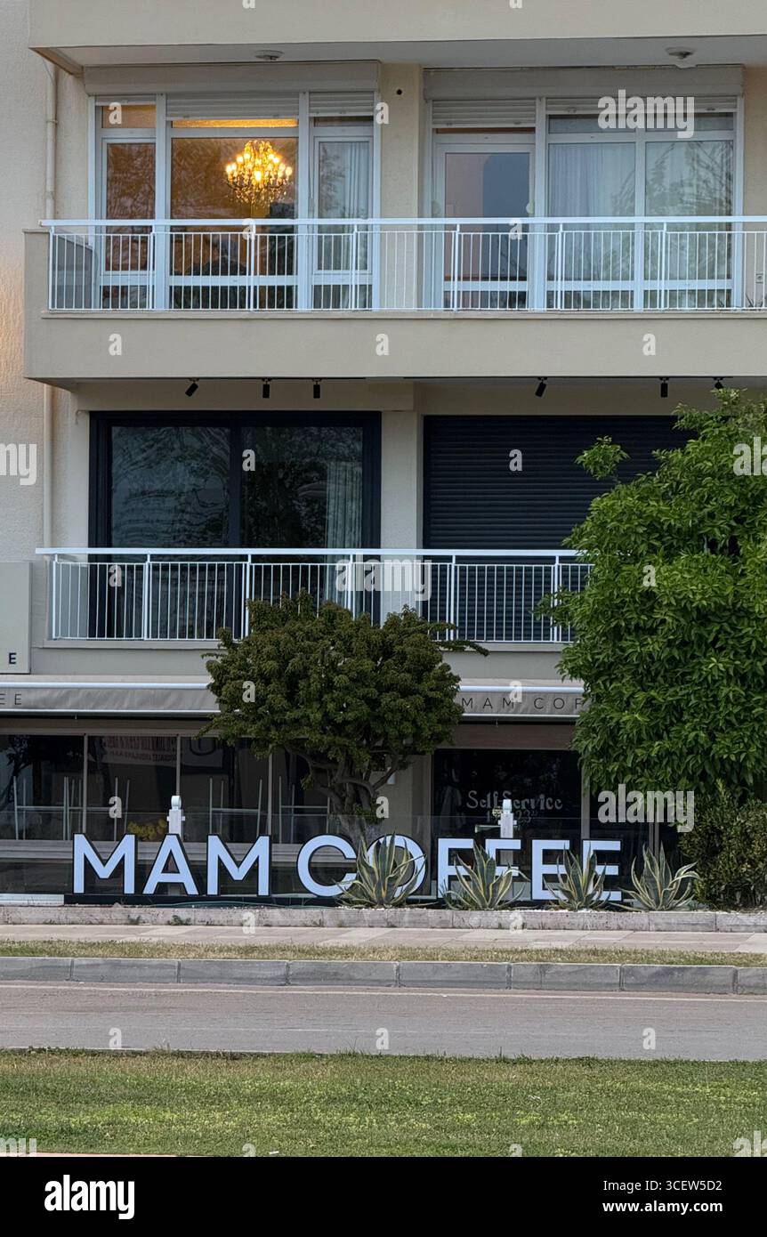 Turkiye, Antalya, 03/17/2025: Mam Cofee. The coffee shop on the city street. House with balconies and panoramic windows Stock Photo
