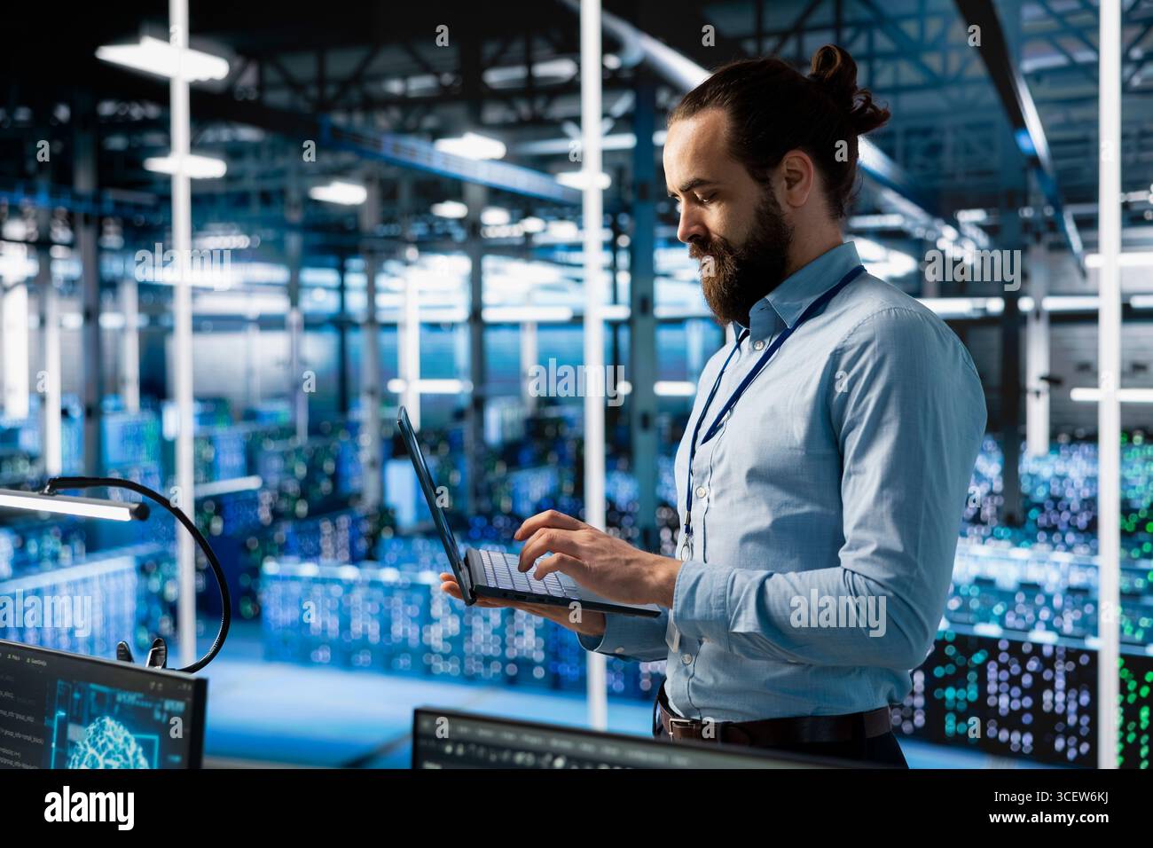 Programmer working in server farm with hardware supporting advanced analytics tasks and data mining. Data center IT expert doing maintenance on racks storing blockchain records Stock Photo