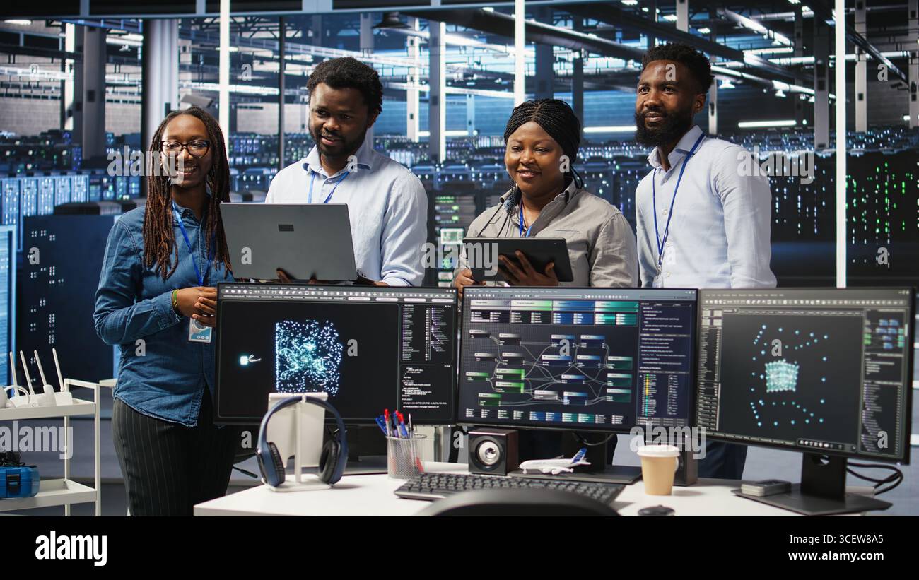 Smiling server hub engineers collaborating, using AI algorithms and node tree systems to categorize unstructured data. Colleagues use visual programming and natural language processing tools, camera A Stock Photo