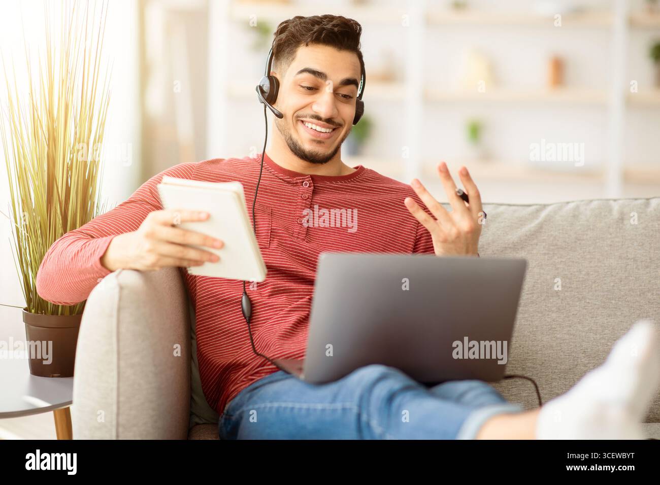 Positive arab guy attending online training from home Stock Photo