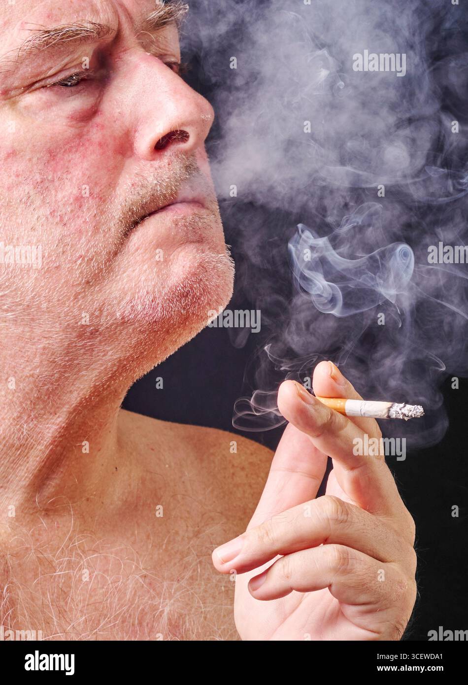 Portrait young man smoking cigarette hi-res stock photography and images