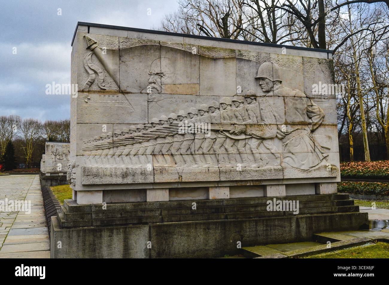 Stone relief at Treptower Park in Berlin depicting Soviet soldiers with rifles, a symbolic World War II memorial honoring fallen heroes. Stock Photo