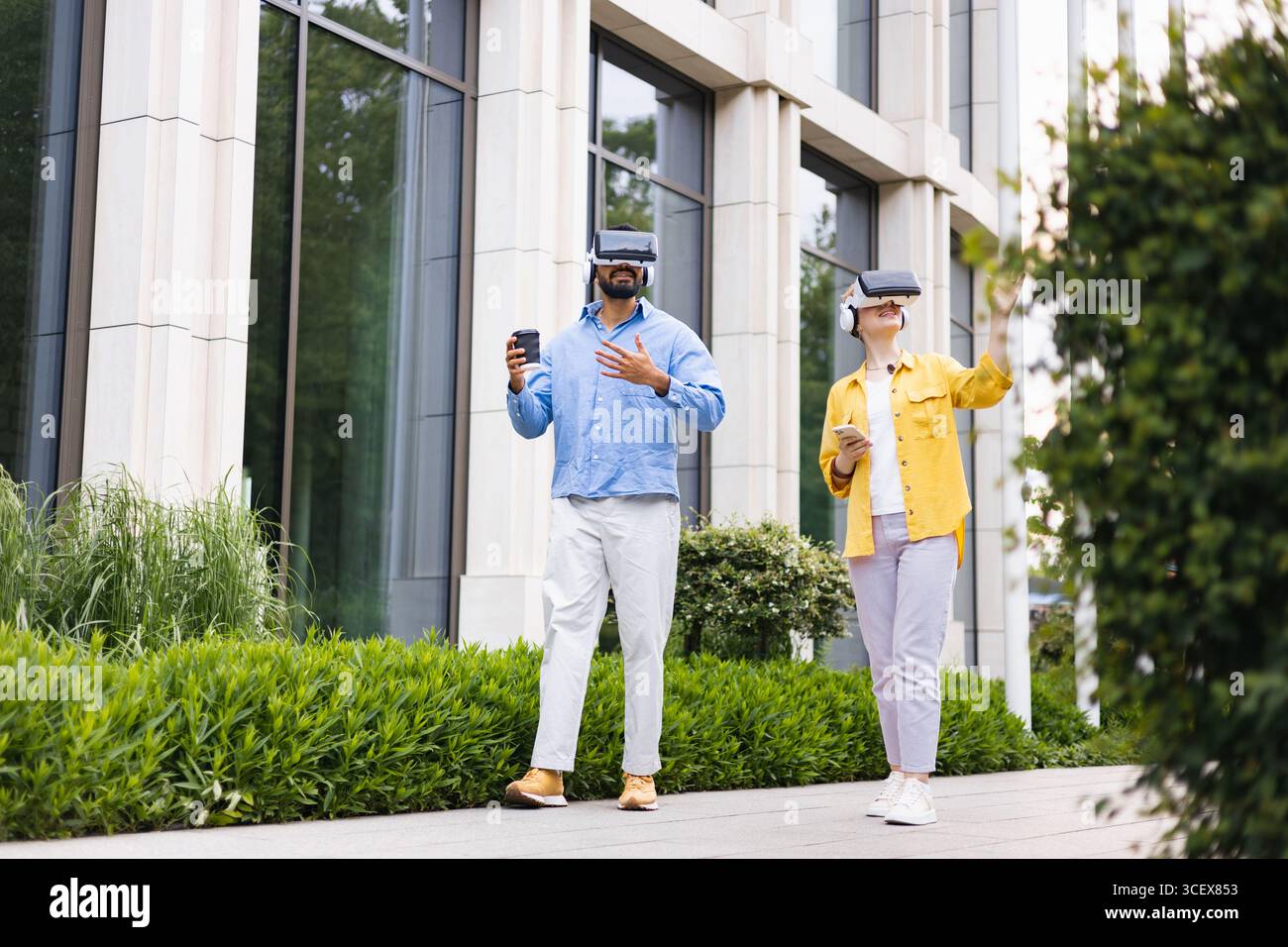 People Using VR Headsets Outdoors Stock Photo