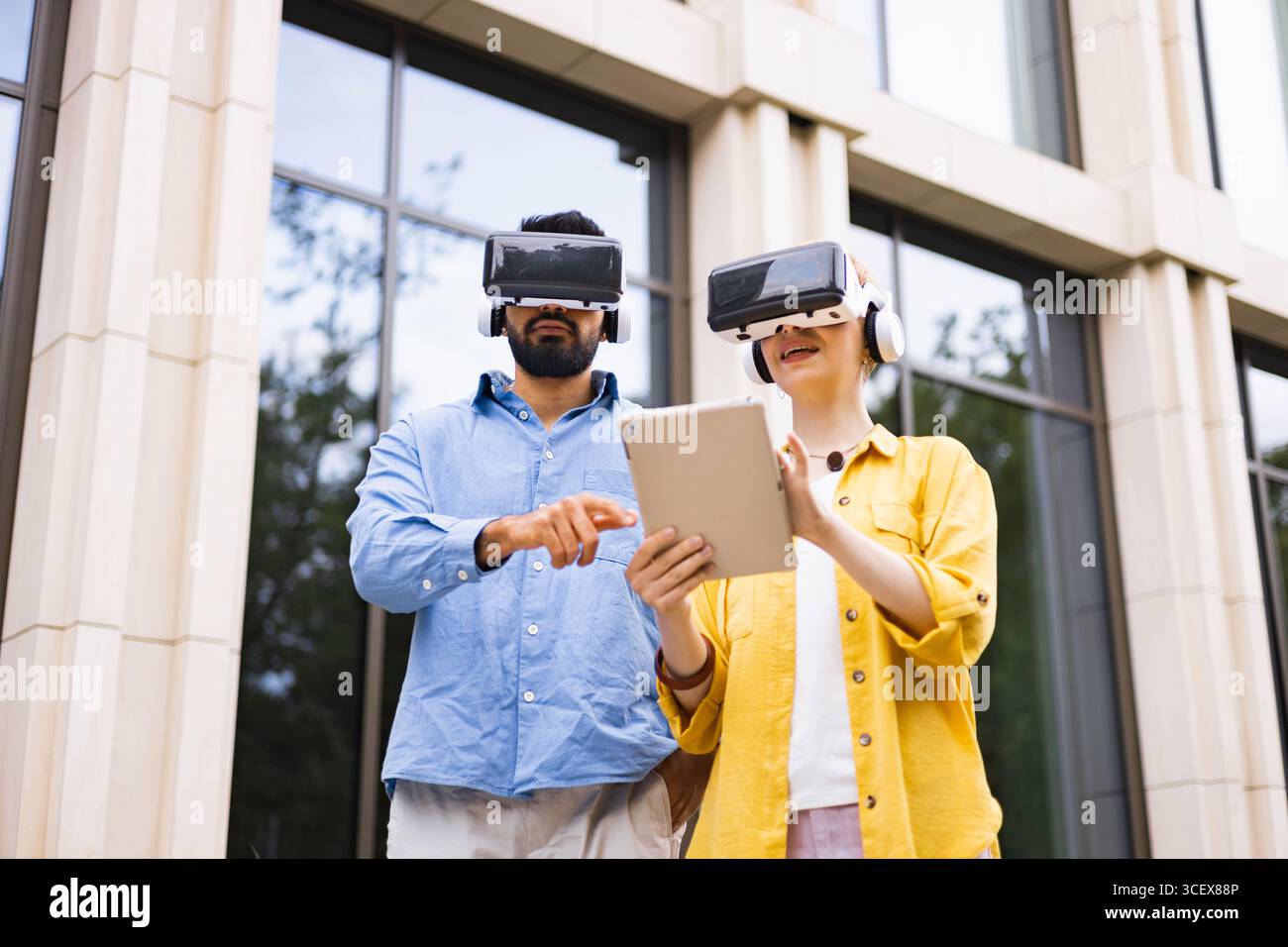 Couple Using VR Headsets Outdoors Stock Photo