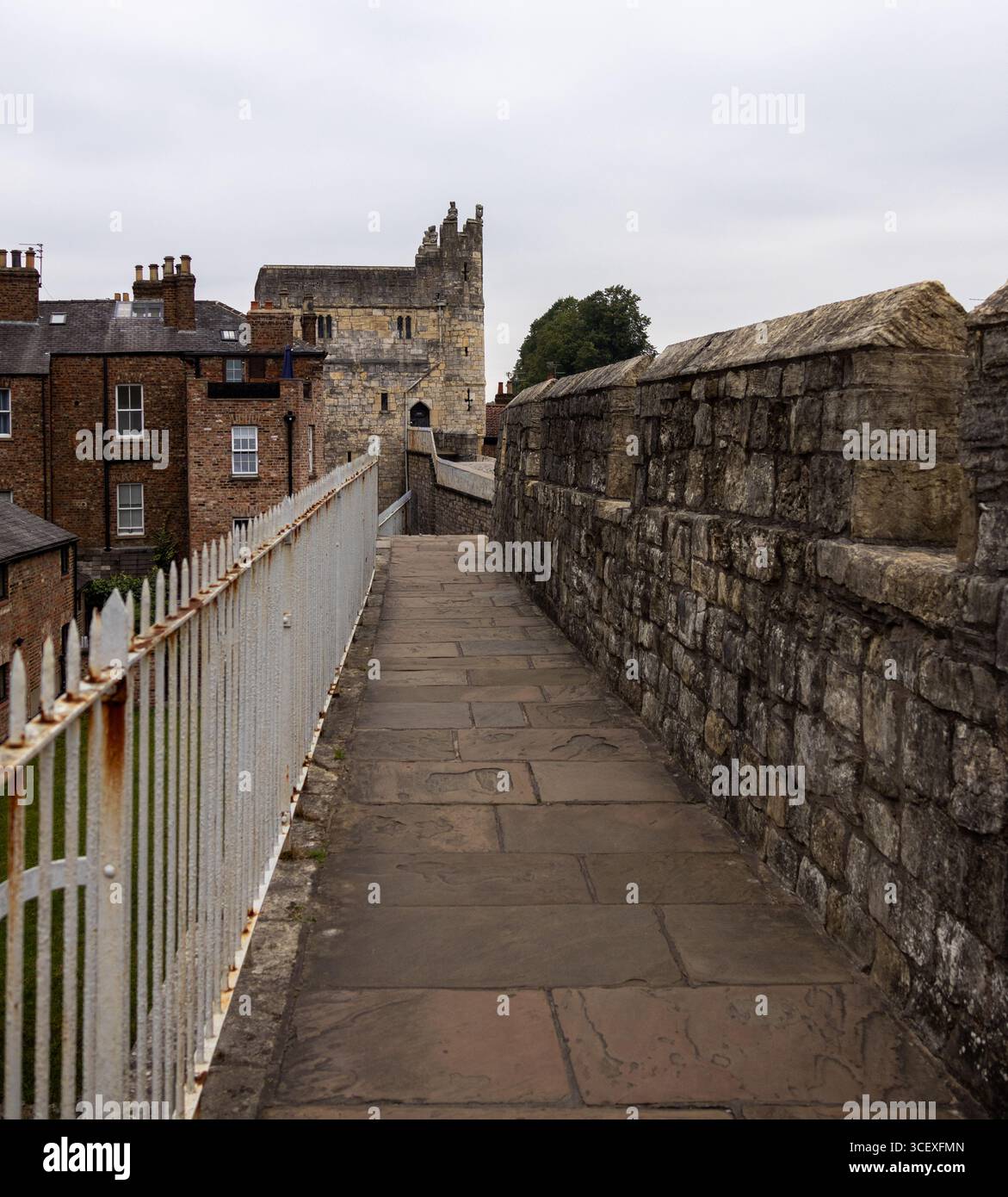 View of a medieval stone tower with battlements and a walkway along ...