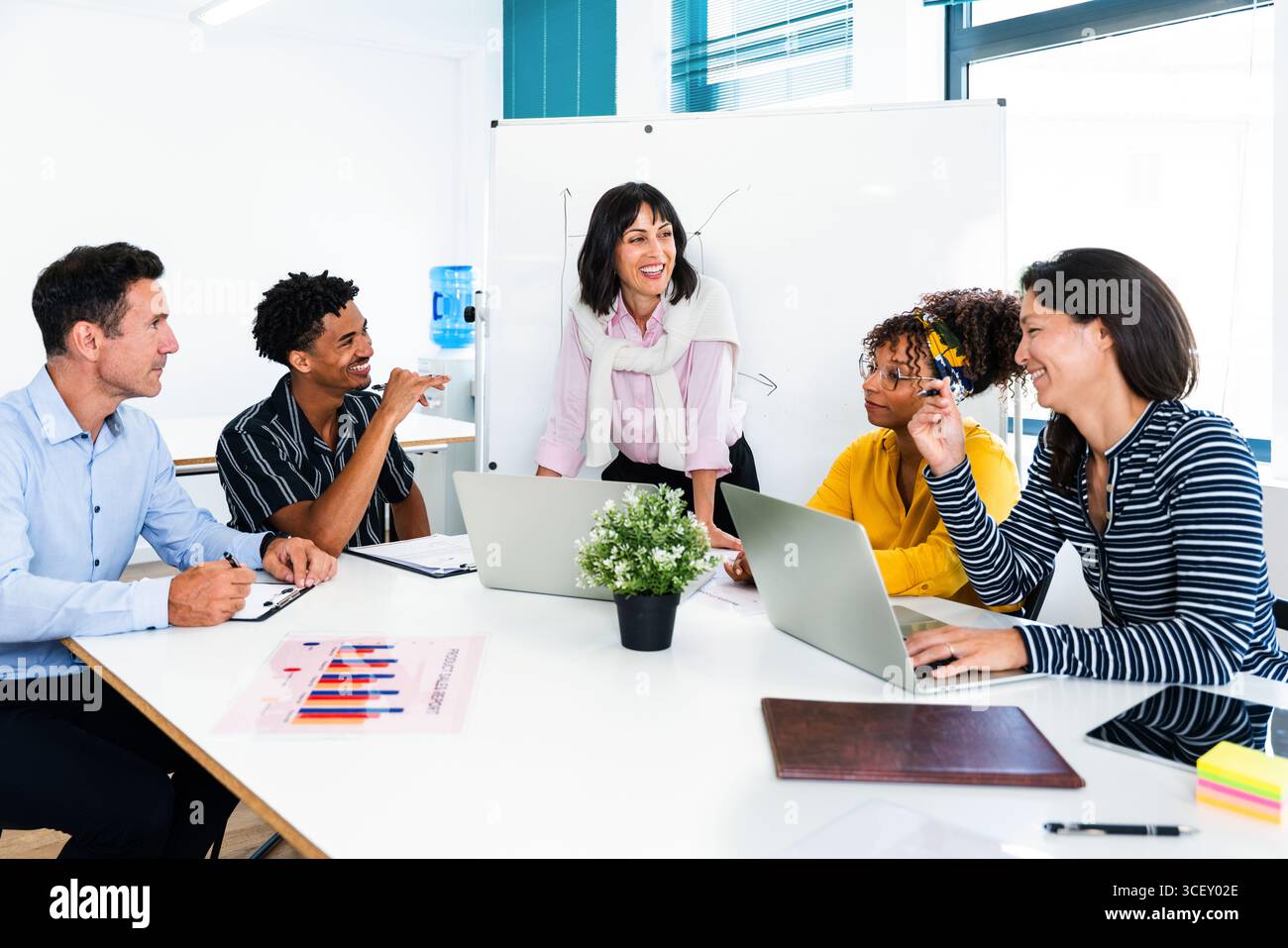 Multi-ethnic business team collaborating on project during meeting in ...