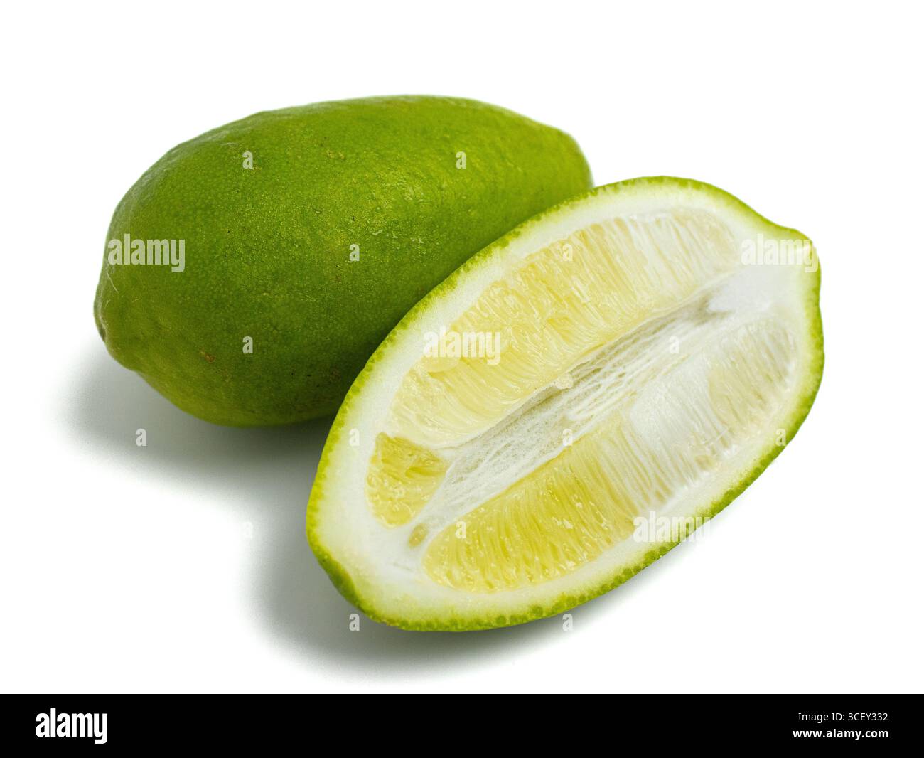 Fresh green lemon, whole and sliced half, isolated on white background Stock Photo