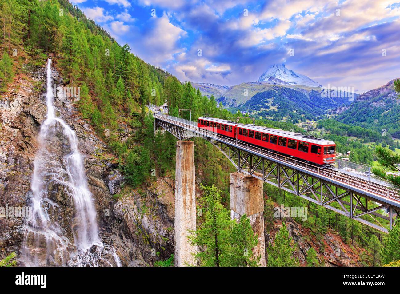 Zermatt, Switzerland. Gornergrat tourist train with waterfall, bridge and Matterhorn. Valais region. Stock Photo
