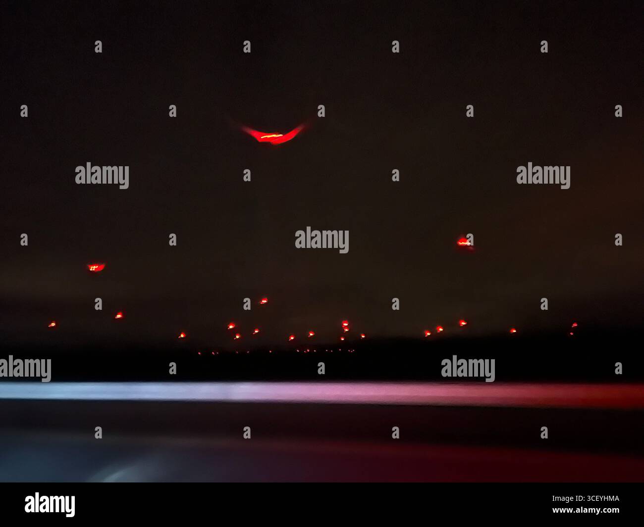 nighttime red illumination of wind turbines in the fields of Austria - Smartphone Captured Stock Image