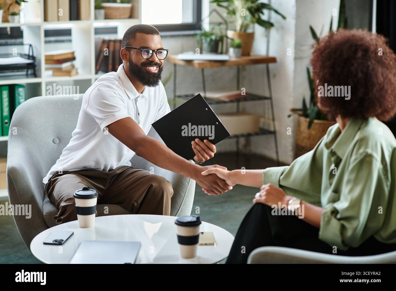 Interview In Studio Two young professionals conduct a interview in a stylish studio while ...