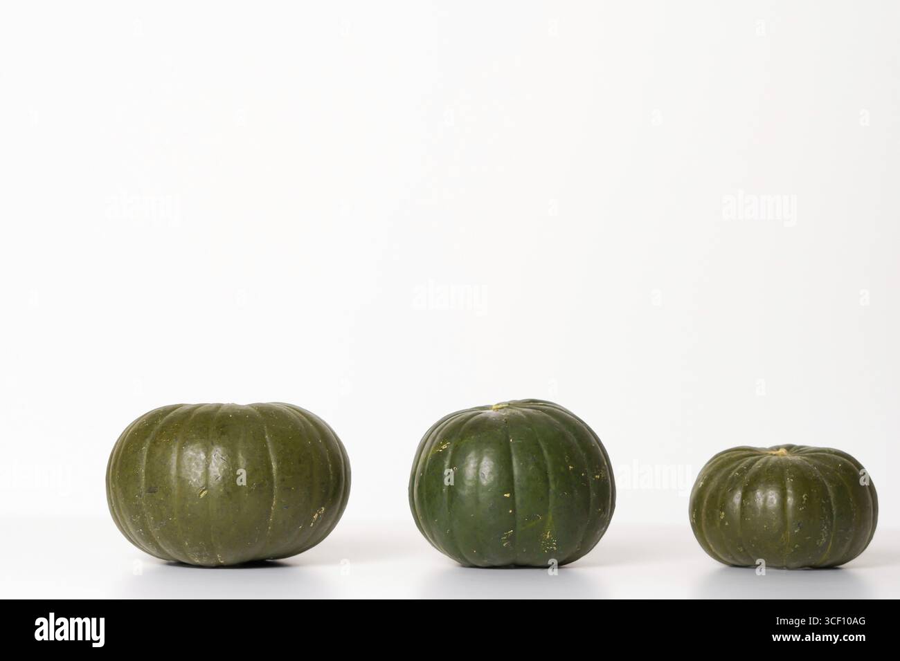 Three green pumpkins isolated on a white background Stock Photo
