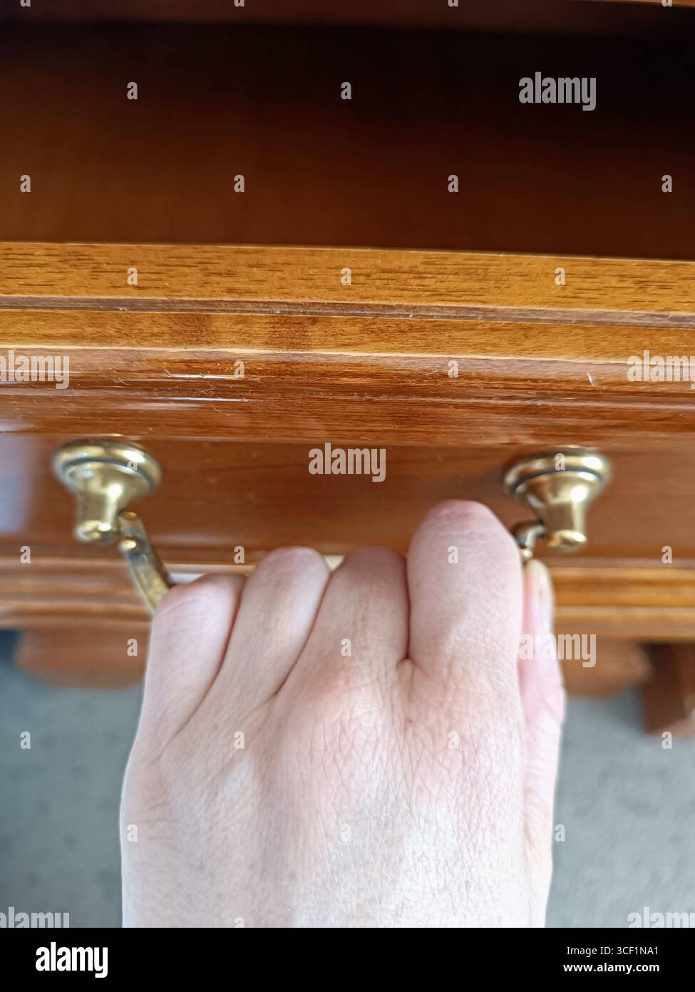 woman hand opens pull wooden drawer cabinet shelf with old handle empty ...