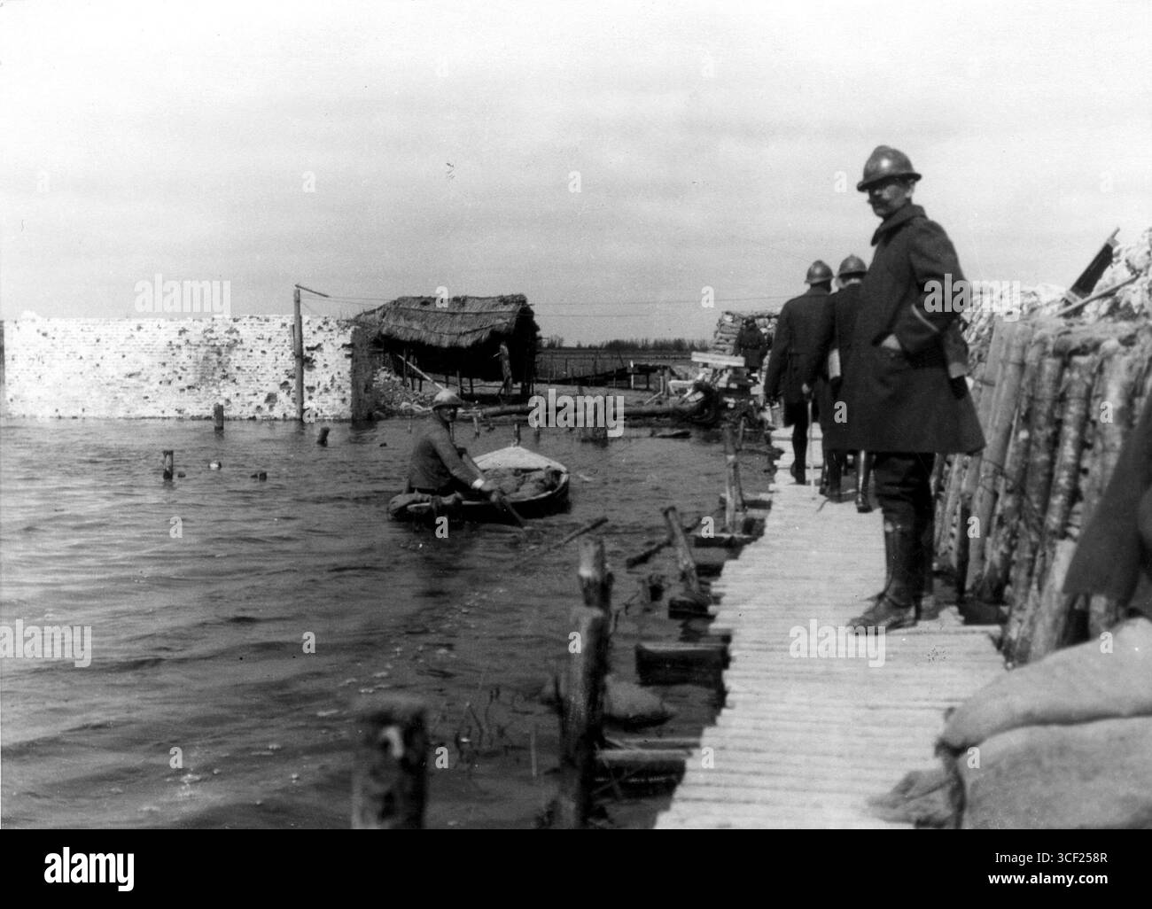 Soldiers stand on a plank above the Yser River during the Battle of ...