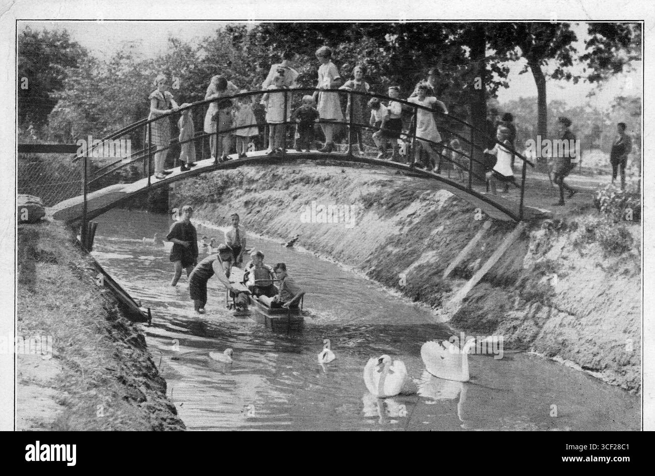 In 1933, a photo captured the small bridge over the canal in the Sport, Play, and Animal Park 'Ons Buiten' located in the Genooi district of Venlo North, a popular recreation area at the time. Stock Photo