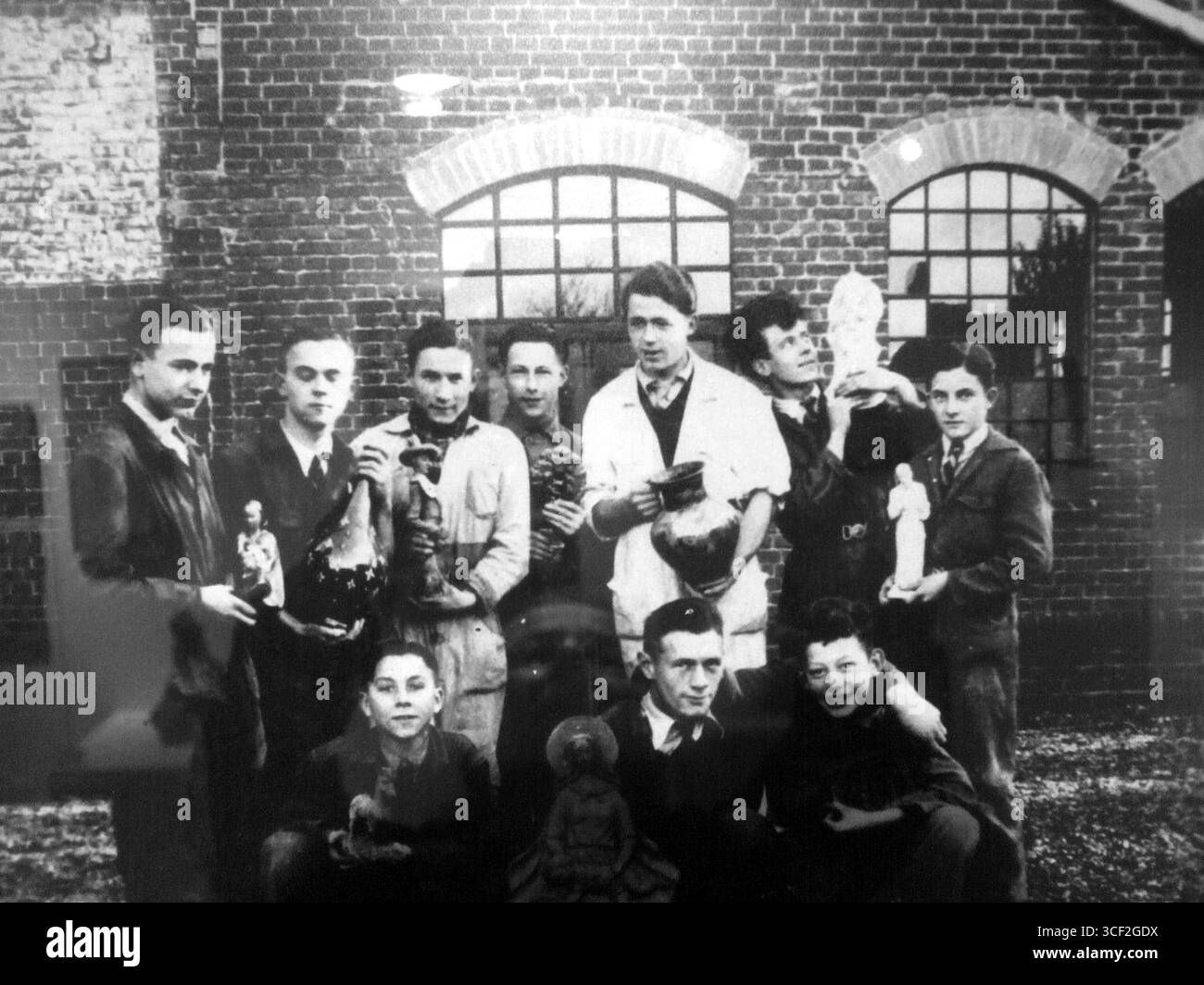 In the 1930s young employees of the Russel-Tiglia Fine Ceramics workshop in Tegelen, including Jac Bongaerts, Harrie Trienes, Mathieu Janssen, and Dries Engelen, were photographed at work. Stock Photo