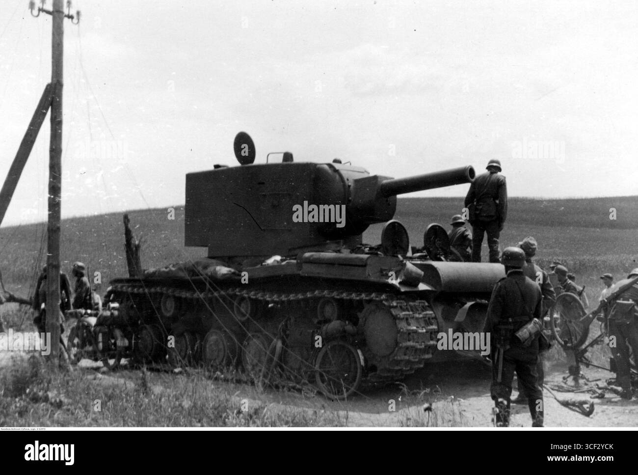 German soldiers examine a damaged Soviet KV-2 tank during the June 1941 ...