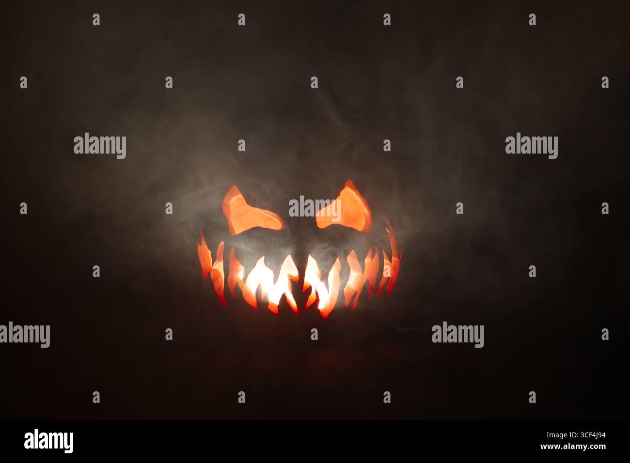 Scary Halloween jack o lantern face glowing in smoke Stock Photo - Alamy