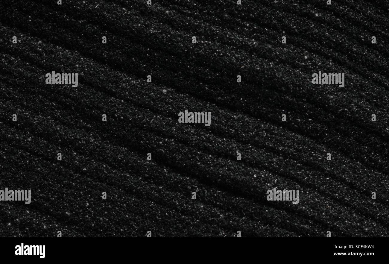 Dark black sand. Stripes and ripples of smooth volcanic sand texture or ...