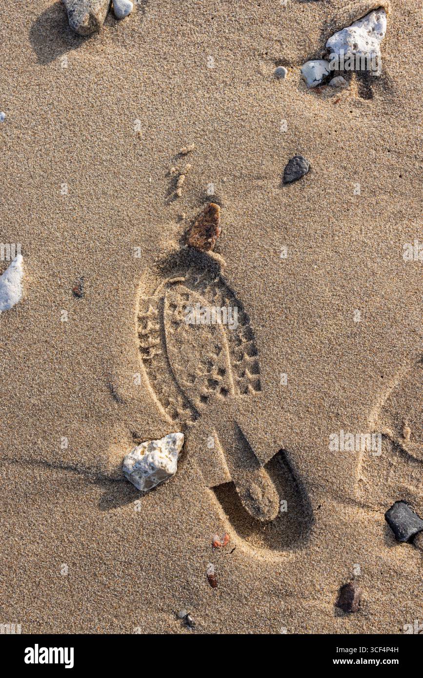 Shoe sole prints in the sandy soil, background image Stock Photo