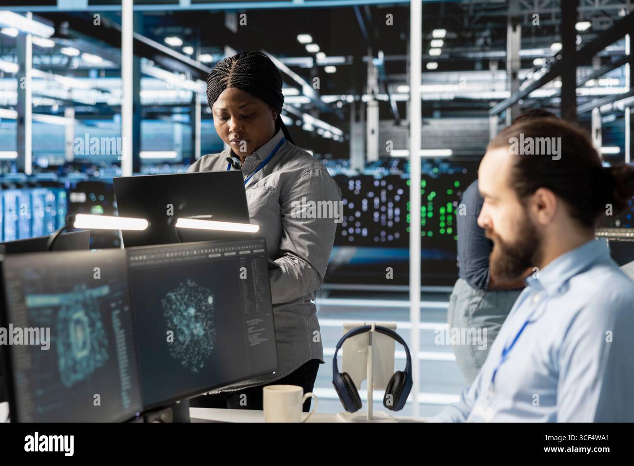 Engineers doing maintenance on blade servers supplying compute power for AI data processing and inference workloads. IT experts overseeing data center arrays managing training datasets Stock Photo