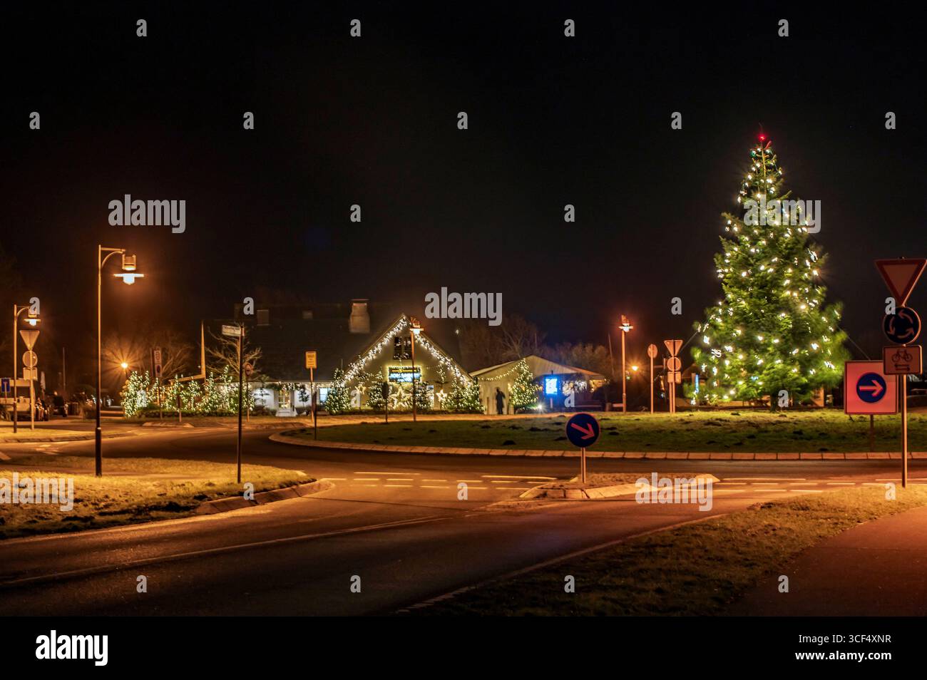 Light trails on the traffic circle with Christmas decorations Stock Photo
