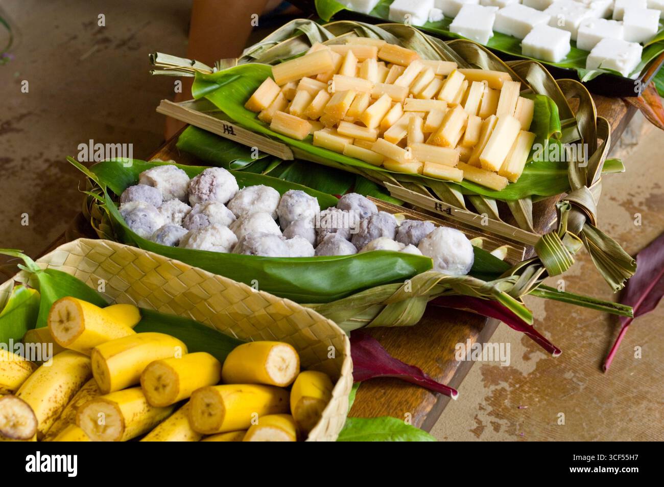 Authentic Hawaiian foods prepared by 3rd grade school students include cut banana, paiai balls, cut sugarcane, and houpia. The Children have been prep Stock Photo