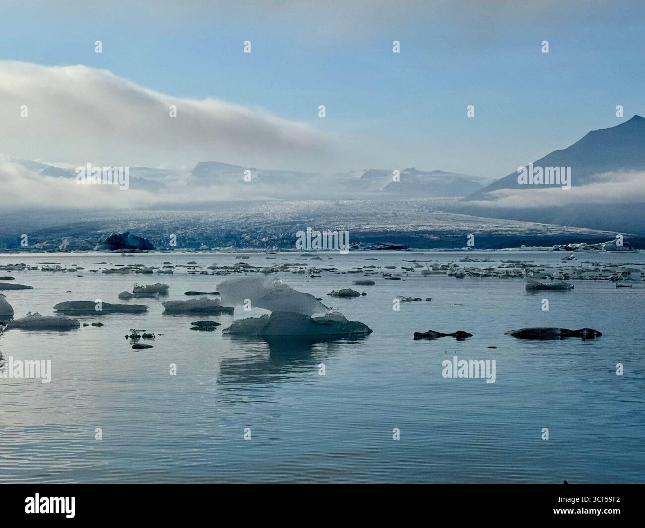 Spectacular view of Breidamerkurjokull glacier, part of Vatnajokull National Park, taken from a kayak floating through icebergs on the glacier lagoon. - Smartphone Captured Stock Image
