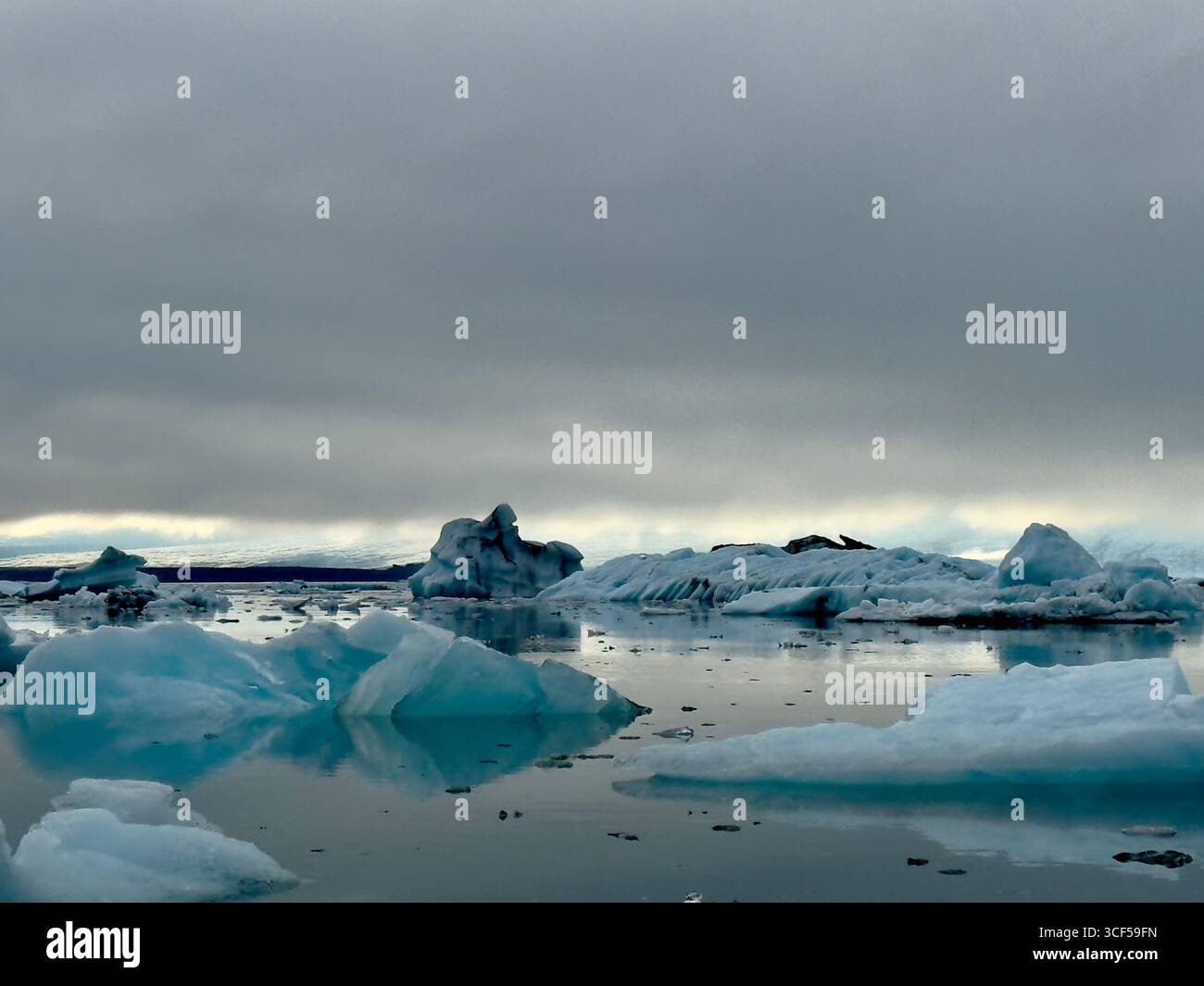 Surreal landscape if icebergs floating in the calm water of Jokusarlon Glacier Lagoon on a summer's eve. - Smartphone Captured Stock Image