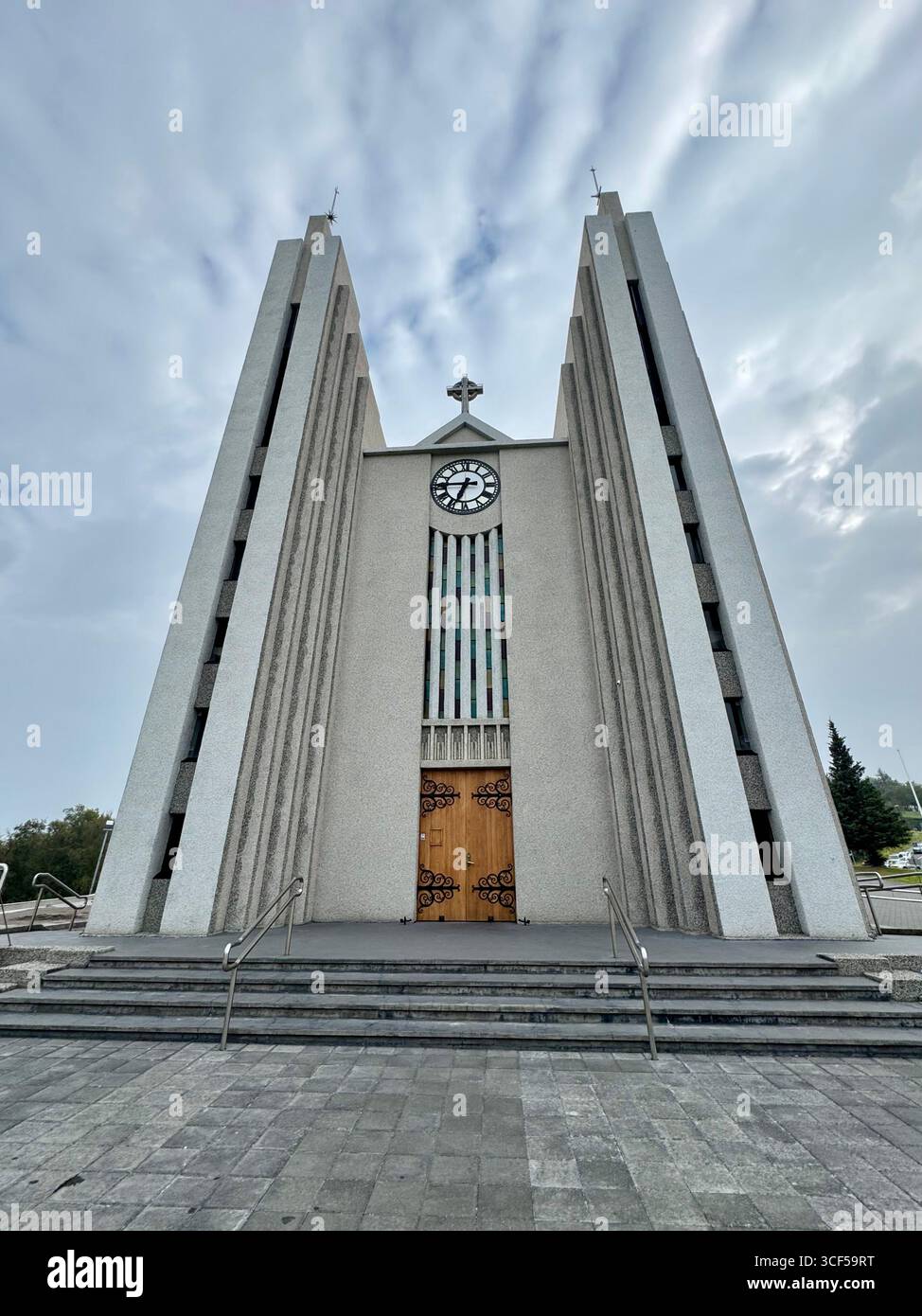 The Church of Akureyi on the top of the hill behind the sign for the Sigurhæðir Memorial House museum. - Smartphone Captured Stock Image