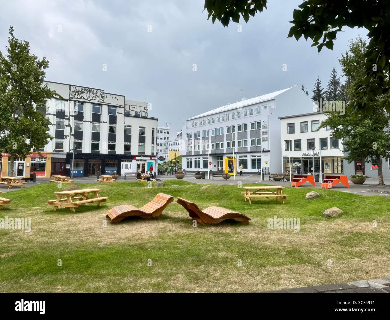 A welcoming green space on a summer's day in amid shops and restaurants in Akureyri's city centre. - Smartphone Captured Stock Image