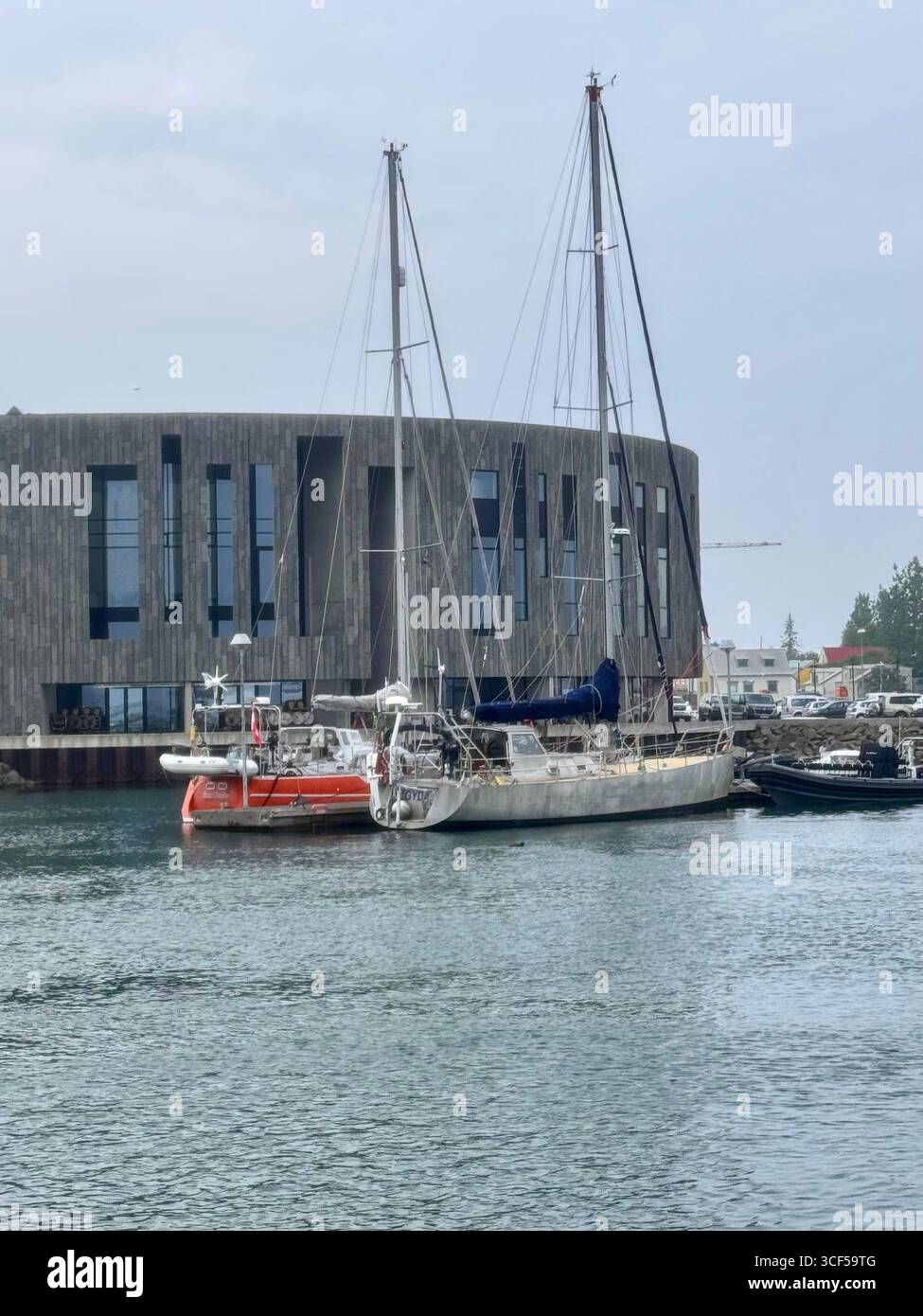 Sailboat docked in front of the Hof Culture and Conference Center in Akureyri. - Smartphone Captured Stock Image