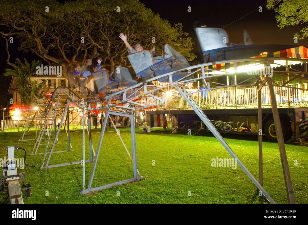 Small Roller coaster for younger children at the Punahou School Carnival, Honolulu, Oahu, Hawaii, USA. The 2006 Punahou Carnival is sponsored by the S Stock Photo