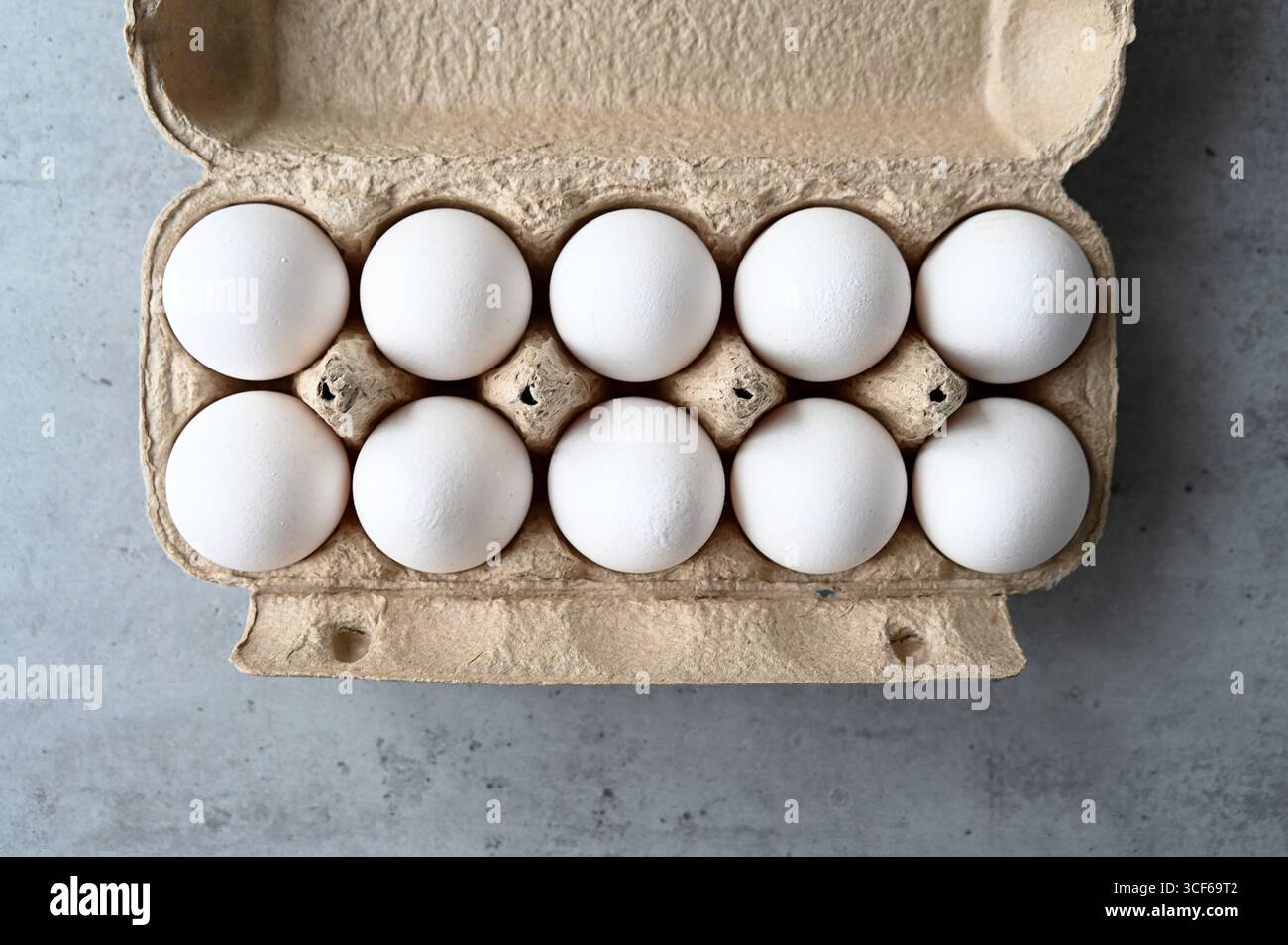 Package with ten white chicken eggs, top view Stock Photo