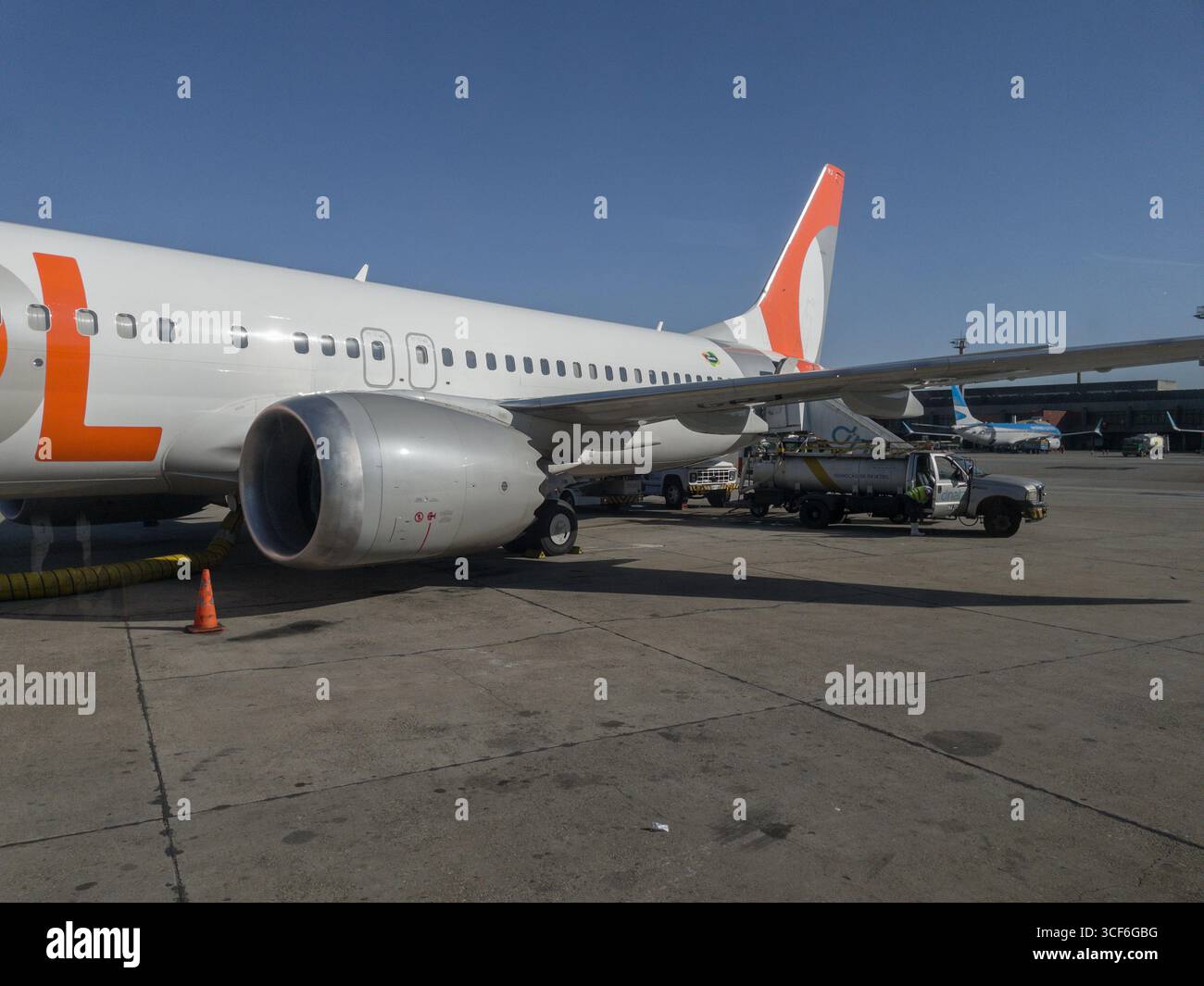 Boeing 737 MAX 8 airplane operated by GOL and waste disposal truck at Sao Paulo/Guarulhos–Governor Andre Franco Montoro International Airport - Smartphone Captured Stock Image