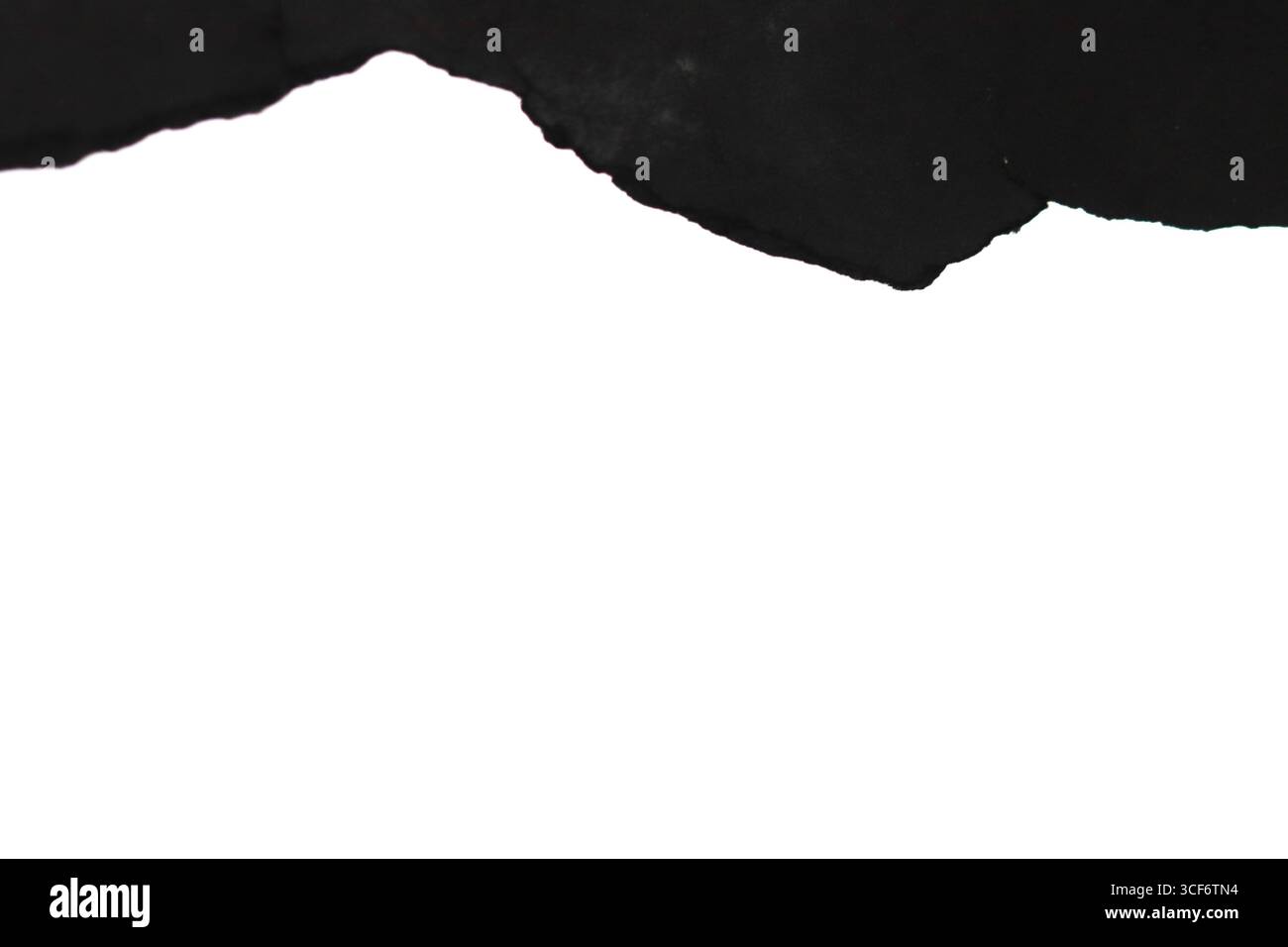 Torn black paper on a white background. Stock Photo
