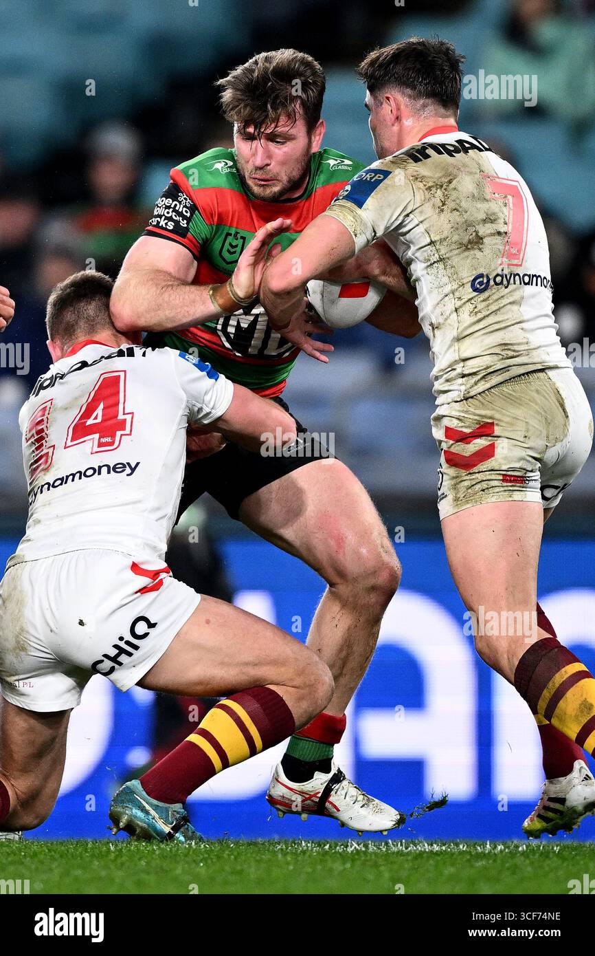 Jai Arrow of the Rabbitohs is tackled by Jacob Liddle (left) and Kyle ...