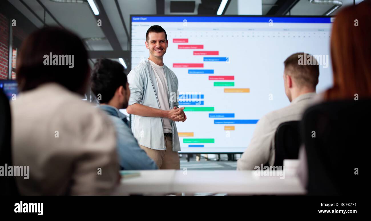 Multicultural Team Presenting Gantt Chart During Office Training Session Stock Photo