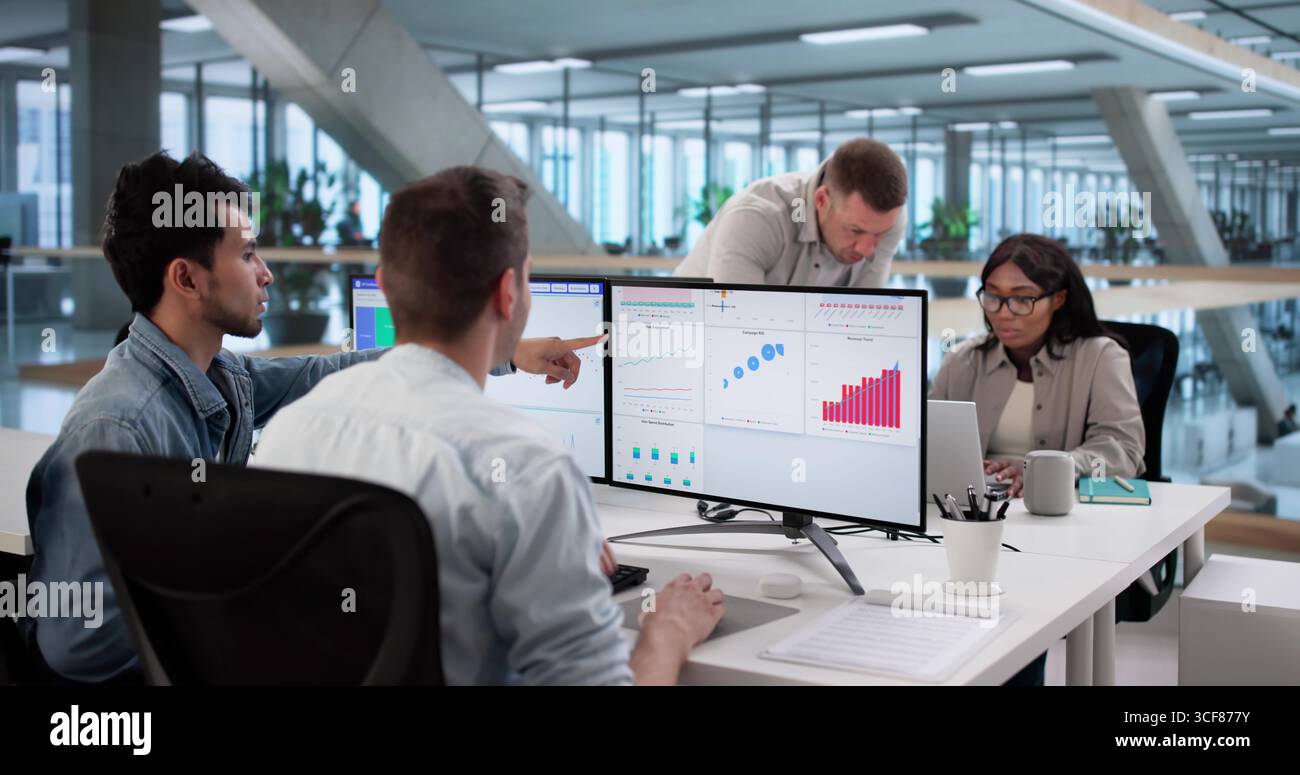 Multiracial Team Analyzing Performance Data On Computer Dashboard Screen Stock Photo