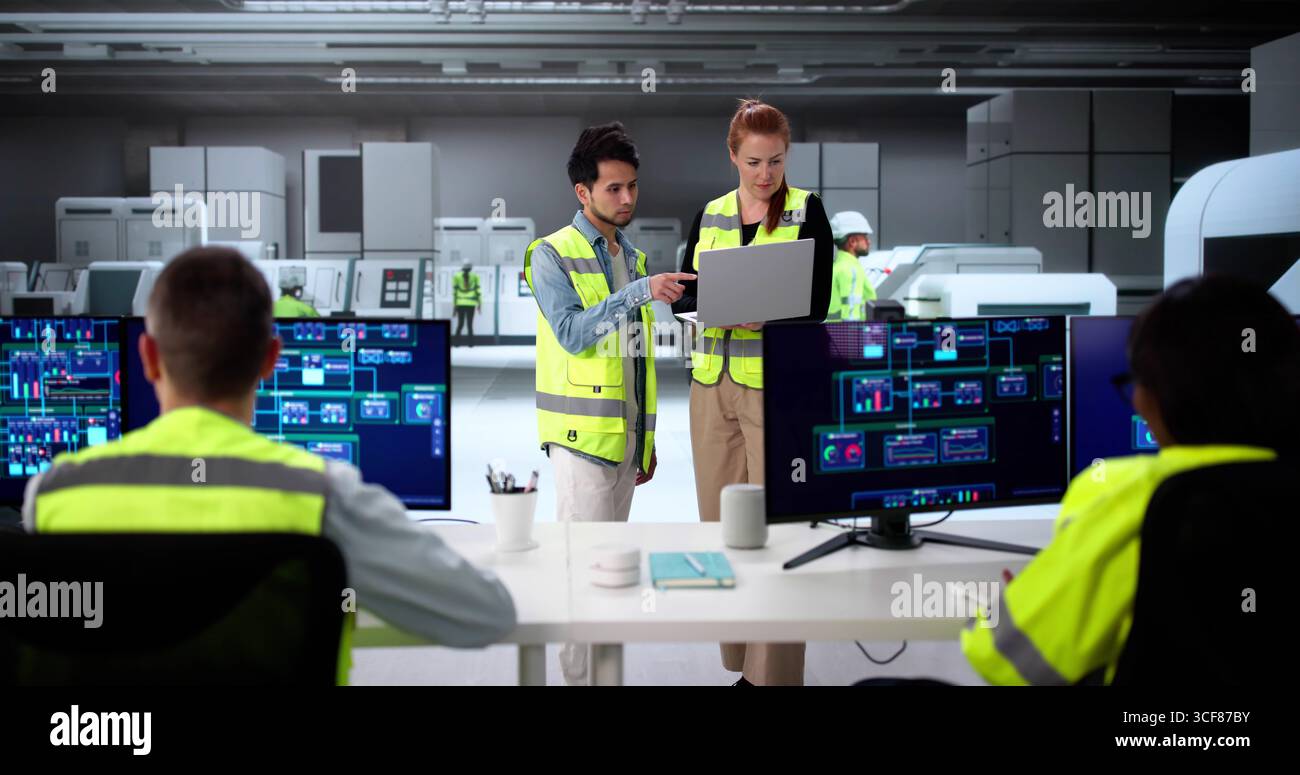Engineers Using Modern SCADA Software To Control Industrial Plant Stock Photo