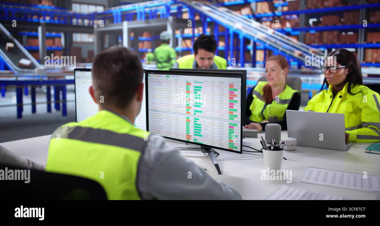 Warehouse Manager Collaborates With Diverse Team To Improve Logistics Efficiency. Stock Photo