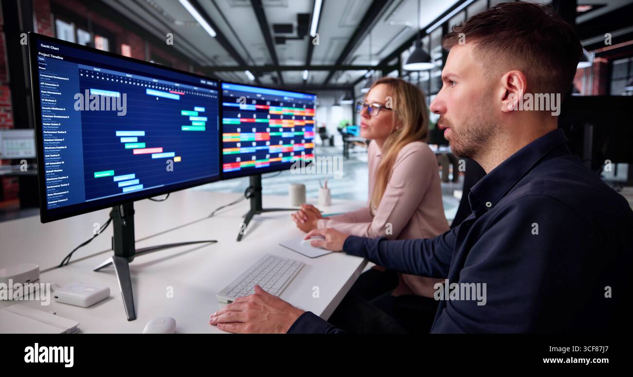 Business Team Brainstorms Project Strategy On Office Computer Together. Company Analyst. Coworkers Collaborate Stock Photo