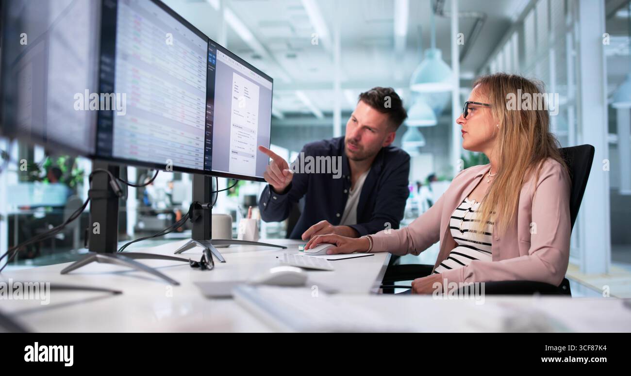 Medical Billing Specialists In Office Using Desktop Computers For Coding. Stock Photo